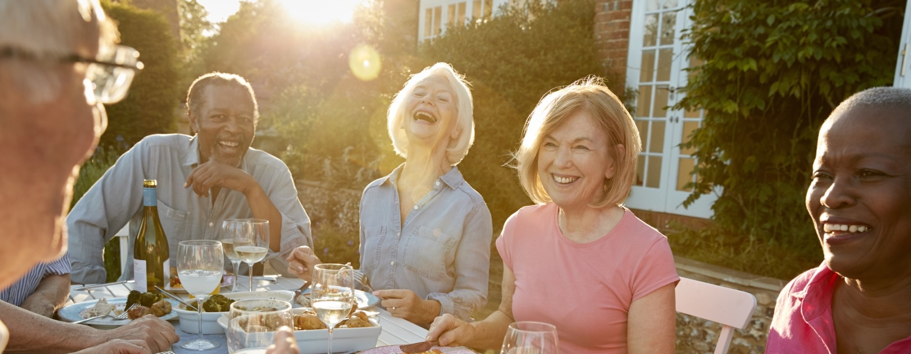 a group of friends eating outdoors at dusk
