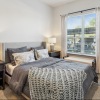 bedroom with night stands, lamps and large windows