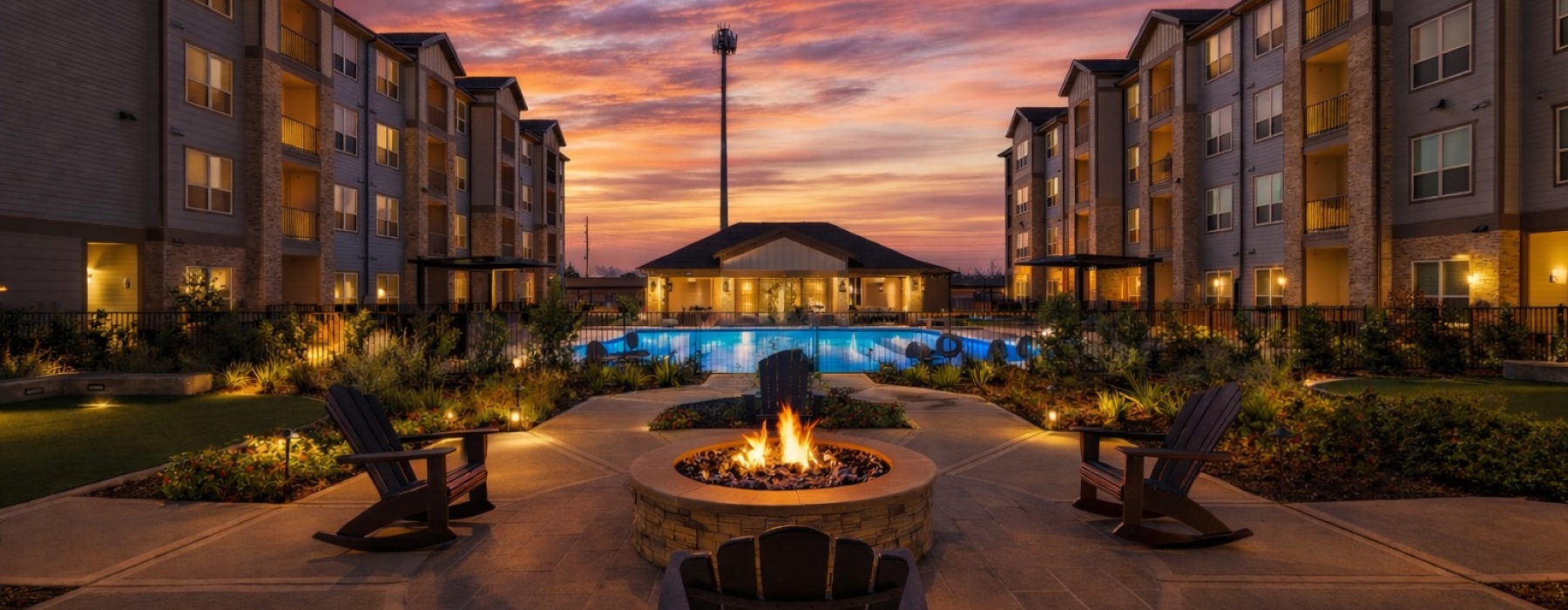 a fire pit in front of a pool at dawn