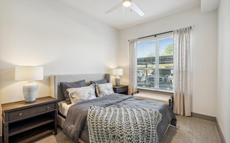 a bedroom with a bed and lamps
